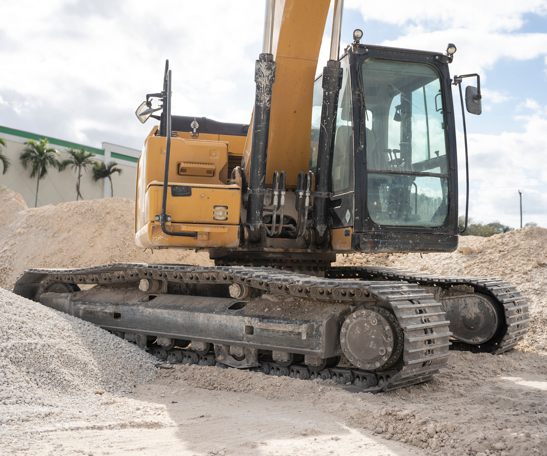 Excavator clearing land